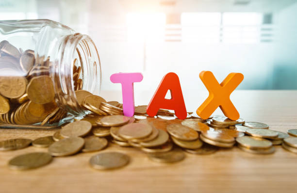 Glass jar saving coins for tax
