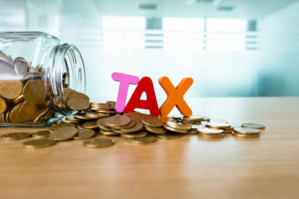 istock Glass jar saving coins for tax 1194023512