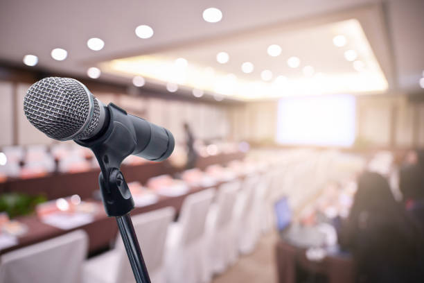 istock Microphone over the blurred business people forum Meeting Conference Training Learning Coaching Concept, Blurred background 1194025357
