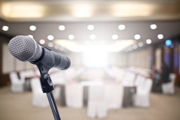 istock Microphone over the blurred business people forum Meeting Conference Training Learning Coaching Concept, Blurred background 1194025358