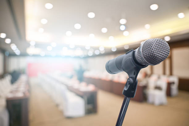 istock Microphone over the blurred business people forum Meeting Conference Training Learning Coaching Concept, Blurred background 1194025363