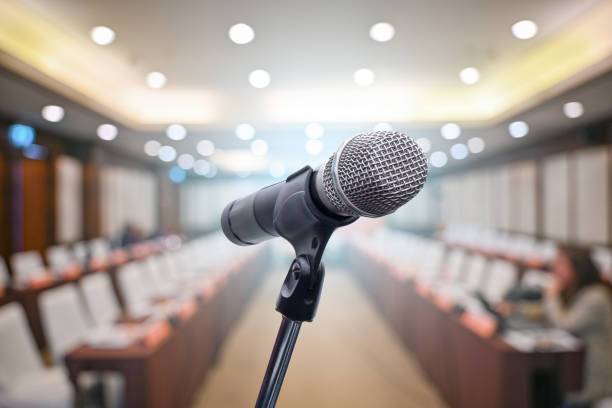 istock Microphone over the blurred business people forum Meeting Conference Training Learning Coaching Concept, Blurred background 1194025367