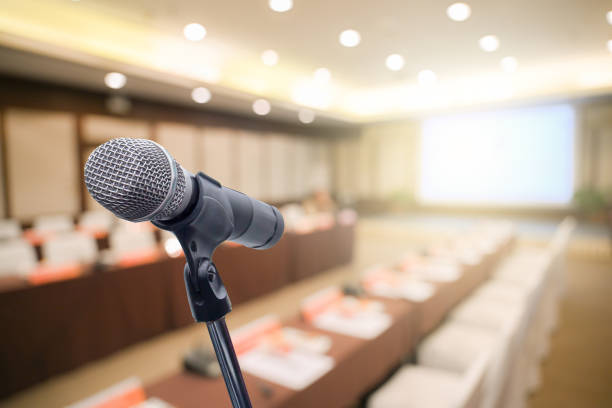 istock Microphone over the blurred business people forum Meeting Conference Training Learning Coaching Concept, Blurred background 1194025373