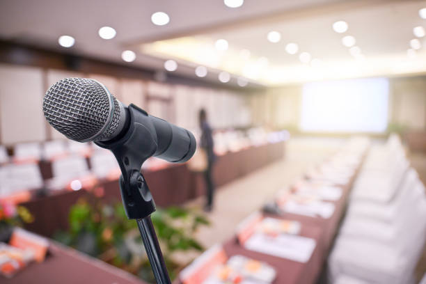 istock Microphone over the blurred business people forum Meeting Conference Training Learning Coaching Concept, Blurred background 1194025377