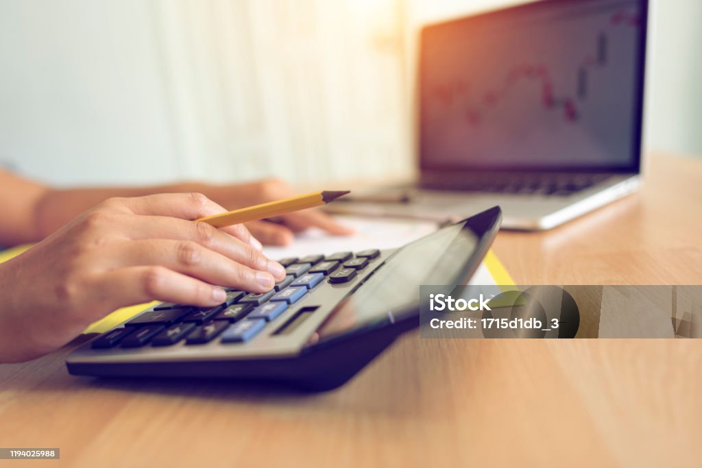 Womanworking A woman working on a calculator in the office Accountancy Stock Photo
