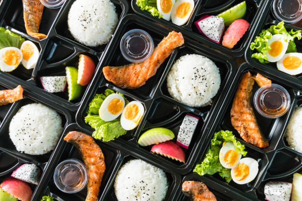 Asian lunch boxes in plastic packages. Ready to eat asian rice box, Asian  Salmon take away plastic boxes. caterer photos stock pictures, royalty-free photos & images