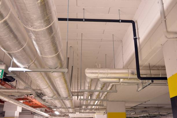 istock Water pipes and cable trays run under ceiling of a building 1194031428