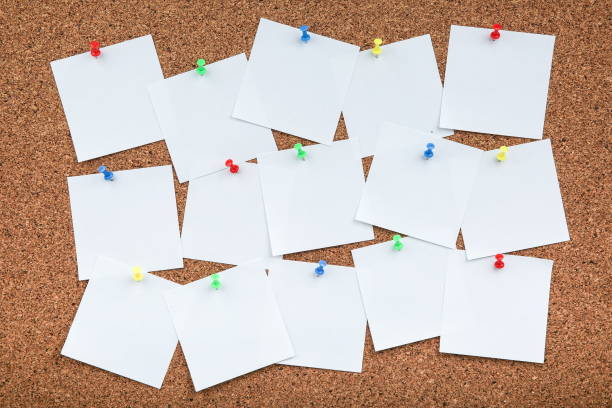 istock cork board with white empty notes of paper with copy space 1194033227