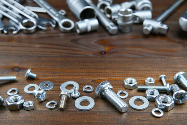 istock background of spanners, socket wrenches, bolts and nuts on dark wooden surface with copy space in the center 1194033271