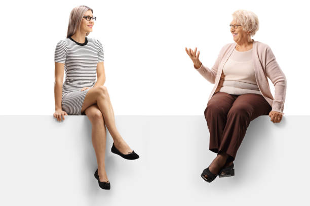 istock An elderly and a younger woman sitting on a panel and talking 1194037566