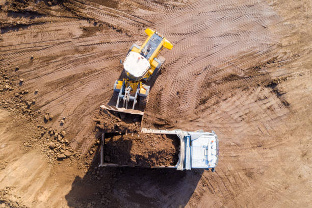 istock Bucket loader loading soil onto a hauler Truck. 1194038574
