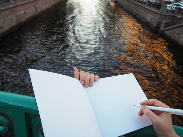 istock Mockup of person's hand holding blank white notebook preparing to write down his or hers ideas. 1194041445