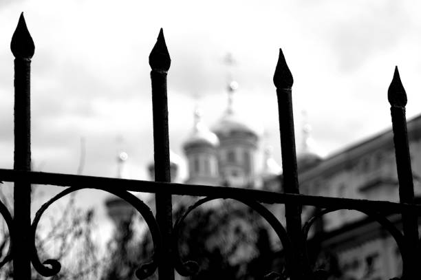 View of the temple through the fence against the blue sky.