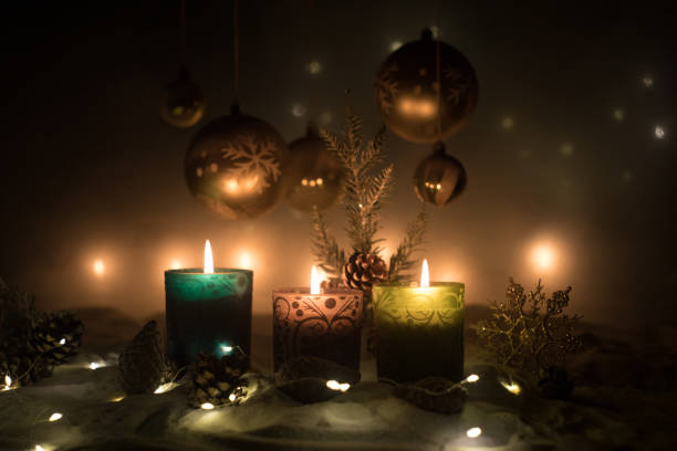 istock Creative artwork decoration. Christmas decoration with burning candles on a dark background. Christmas ornaments over dark golden background with lights. 1194046879