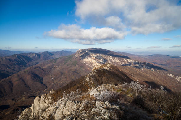 istock Impressive rocky mountain peak under deep blue sky and soft white clouds 1194048727