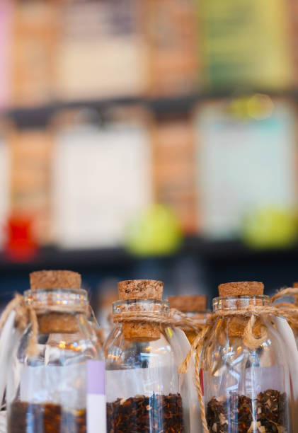 istock Glass bottles with cork lids on shop background 1194048933