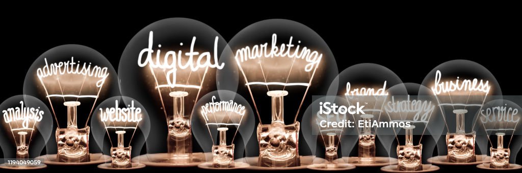 Light Bulbs Concept Photo of light bulbs with shining fibers in a shape of Digital Marketing, Website, SEO and Strategy concept related words isolated on black background Marketing Stock Photo