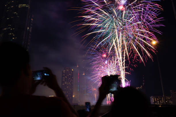 istock Cheering crowd watching fireworks at night; New year concept. 1194051301