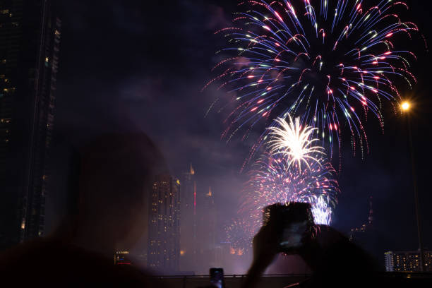 istock Cheering crowd watching fireworks at night; New year concept. 1194051315