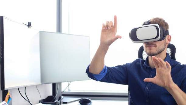 istock Young man wearing virtual reality glasses in modern interior design coworking studio. 1194055065