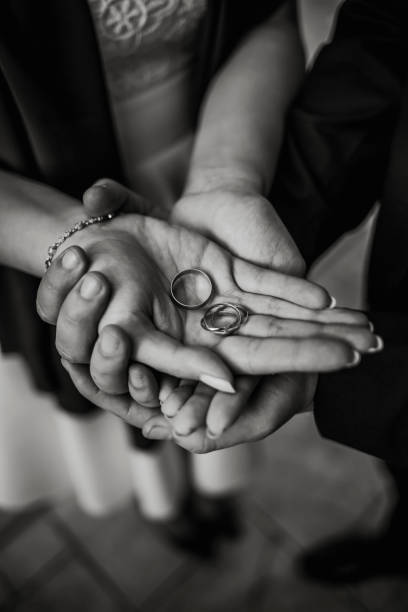 istock Lovely couple holding wedding rings 1194057496