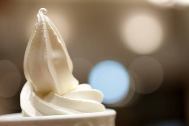 Soft serve ice cream in cup with light background