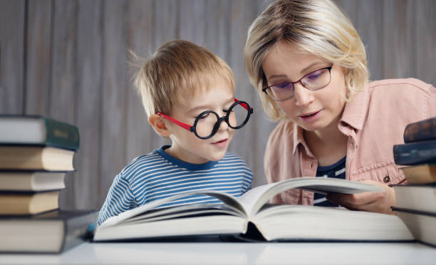 istock five years old child reading a book at home with mother 1194058338