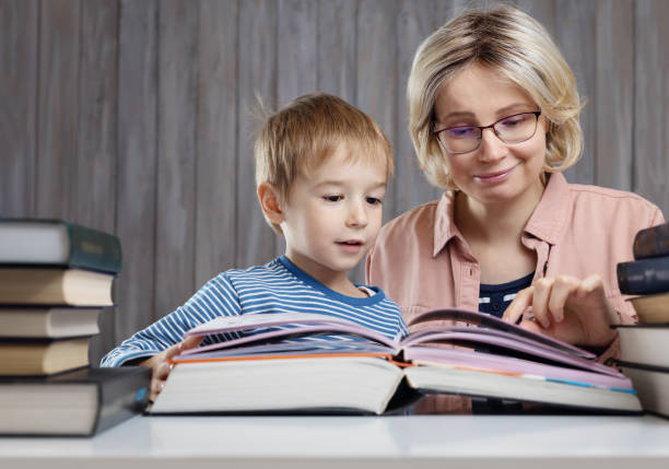 istock five years old child reading a book at home with mother 1194058401