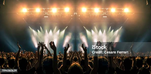 Concert Stage People Are Visible Waving And Clapping Silhouettes Are Visible Stock Photo - Download Image Now