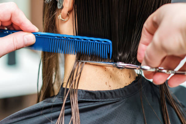 istock Professional stylist is cutting black hair 1194060842