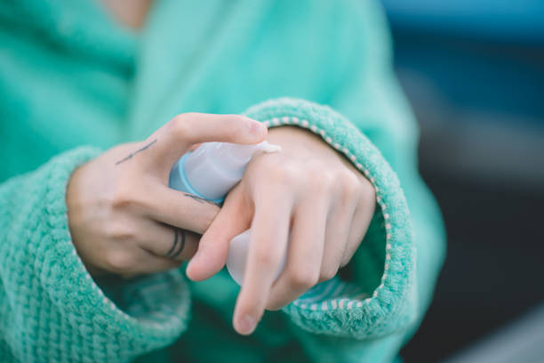 an asian chinese hands applying lotion