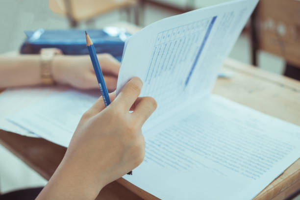 istock Education art practice concept : Man Hands high school, university student holding pencil for testing drawing and writing paper sheet and exercise in art classroom 1194069074