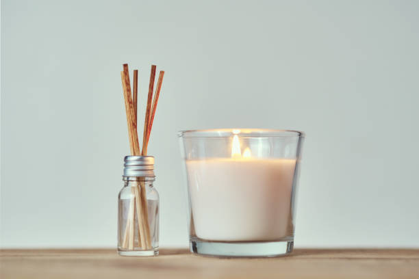 istock Burning candle with aroma sticks in a glass bottle 1194071393