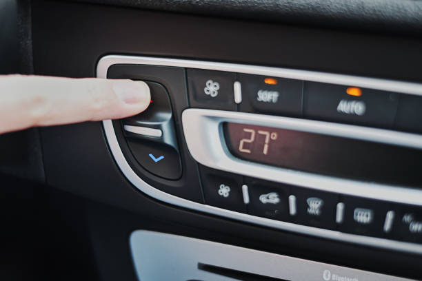 woman hand set the temperature on air conditioner panel in car. climate control panel - car air conditioner vehicle interior driving imagens e fotografias de stock