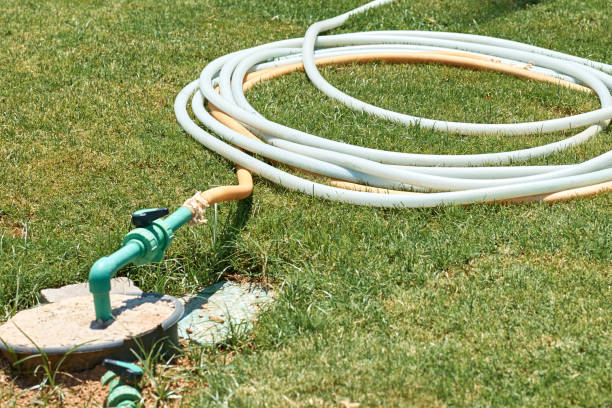 istock watering hose twisted on the green grass in summer day 1194074312