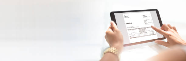 istock Businesswoman Checking Invoice On Digital Tablet 1194075942