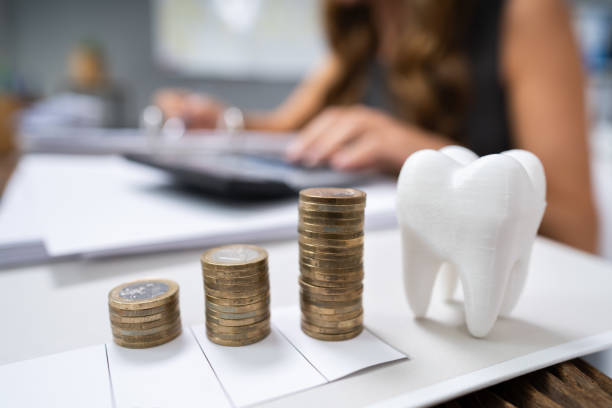 istock White Tooth In Front Of Woman Calculating Bill 1194076207