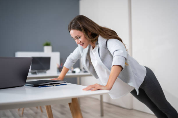 istock Businesswoman Doing Push Up On Office Desk 1194076926