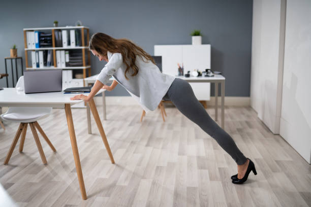 istock Businesswoman Doing Push Up On Office Desk 1194076931