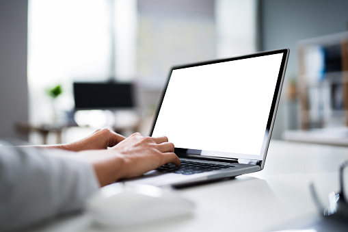 Close-up Of Businesswoman Working On Laptop In Office