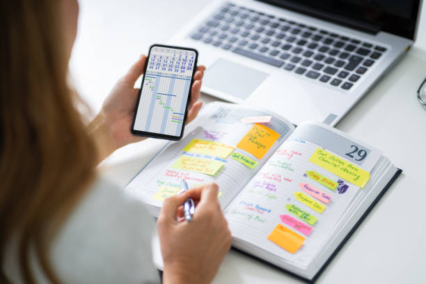 istock Businessperson Writing Schedule In Diary 1194077019