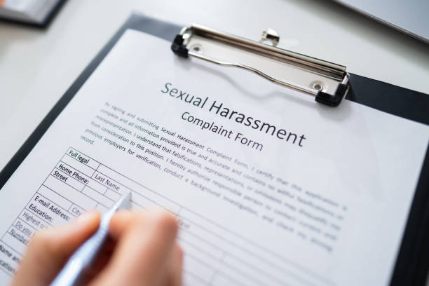 istock Human Hand Filling Sexual Harassment Complaint Form 1194077038