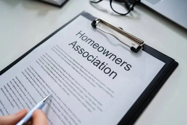 Person Reading  HOA Rules And Regulations Document
