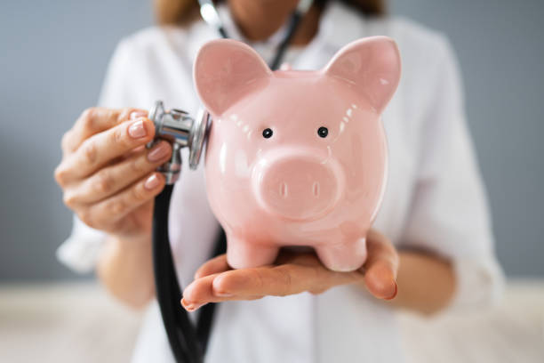 istock Doctor Examining Piggybank With Stethoscope 1194077256
