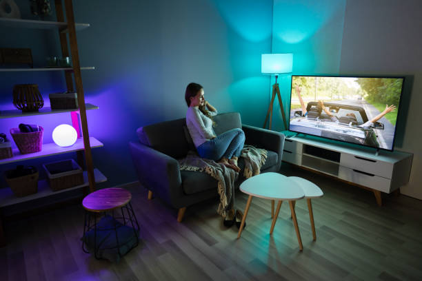 istock Woman Watching TV While Relaxing On Sofa 1194080275