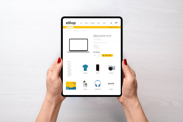 istock Modern electronic commerce web site on tablet in woman hands. Top view, flat lay scene. Concept of shopping online 1194084822