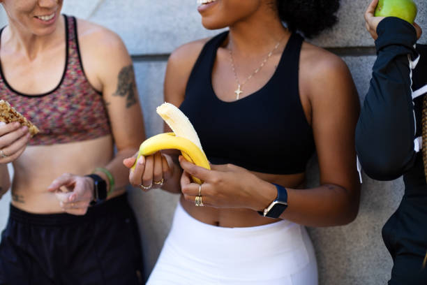 istock Multi-ethnic women eating banana after training session 1194087344