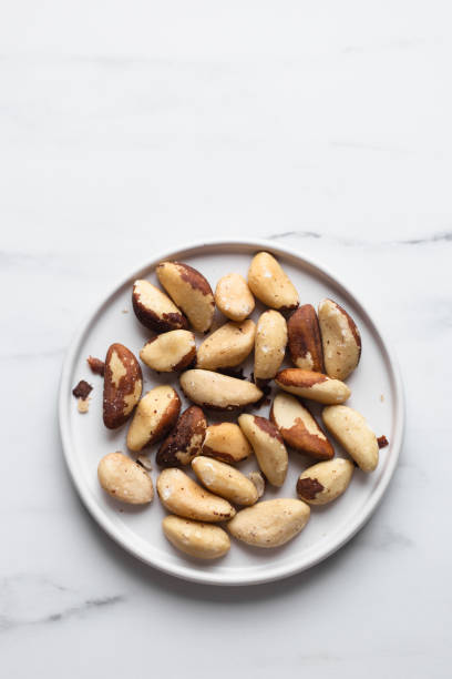 istock Brazil nuts on white marble background 1194091287