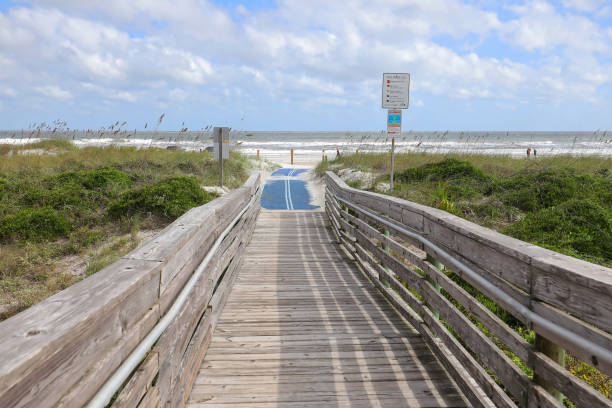 walkway to Amelia Beach, Florida Blue roll out mat for handicapped beach access to Amelia Beach, Florida, USA. beach mat stock pictures, royalty-free photos & images