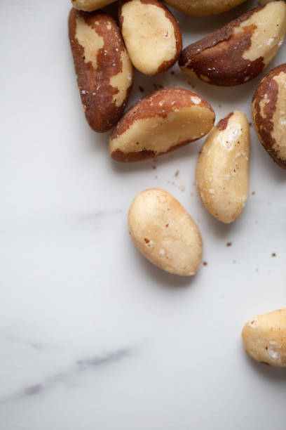 istock Brazil nuts on white marble background 1194091811